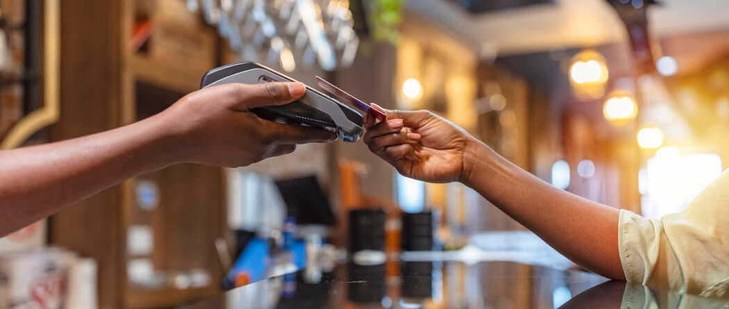 Close up of hands paying with credit card